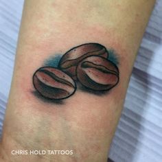 a tattoo with coffee beans on it