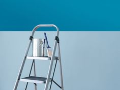 a blue and white striped wall with a ladder holding a bucket and two toothbrushes