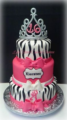 a three tiered cake decorated with zebra print and pink ribbon, has a tiara on top