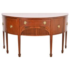 a wooden table with two drawers on one side and an oval shaped drawer on the other