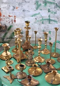 a table topped with lots of different types of candlesticks on top of each other