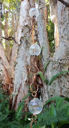 an outdoor wind chime hanging from a tree