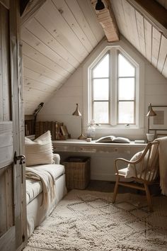 an attic bedroom with white walls and wooden ceilings, a window over the bathtub