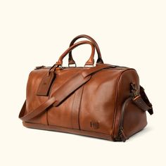 Premium tan leather weekender bag with spacious interior, reinforced stitching, and stylish brand logo. Buffalo Jackson, Gold Dessert, Waxed Canvas Bag, Canvas Travel Bag, Leather Duffel Bag, Rugged Leather, Chocolate Gold, Leather Duffel, Mens Travel