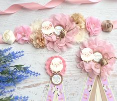 some pink and gold ribbons with flowers on them