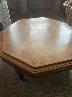 a wooden table sitting on top of a carpeted floor