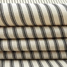 four pieces of black and white fabric stacked on top of each other in different sizes