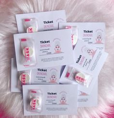 four tickets and two packets of sunscreen on a pink fur covered surface with white text