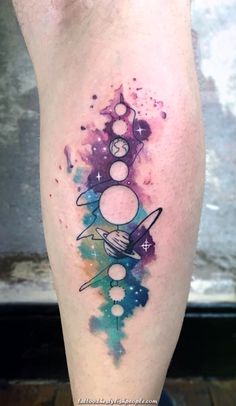 an artistic tattoo on the leg of a man with space and planets in it,