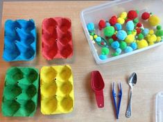 the table is set up with plastic eggs, spoons and other crafting supplies