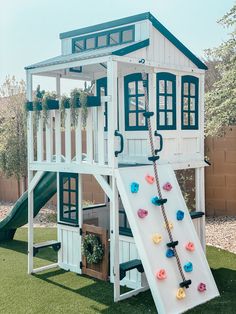 a play house with a slide and climbing frame