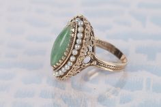 Awesome Yellow Gold Ring, Jade with a Pearl Halo! It's a navette shaped ring, with a ton of detail. Almost every surface of the ring is detailed. The pearls and the jade are held in place very well, no wiggling! It's a fun piece that looks great and you don't see them like this often! We can ship overnight if you need it fast! Formal Marquise Jewelry With Intricate Design, Art Deco Pear-shaped Jewelry For Formal Occasions, Antique Marquise Diamond Cut Jewelry, Wedding Jewelry Marquise Shape With Hallmark, Formal Pear-shaped Heirloom Jewelry, Formal Heirloom Pear-shaped Jewelry, Vintage Marquise Gemstone Jewelry, Vintage Marquise Jewelry Hallmarked, Vintage Marquise Hallmarked Jewelry