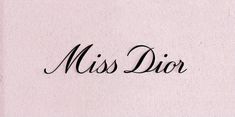 the word miss dior written in cursive writing on a pink paper background