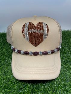 Football weather can be unpredictable so even more reason to snag this darling has made hat!  ! These hats can be worn just with the football sparkle  or you can add the clip on football and sparkle clip to add extra oolala!  The main picture shows the trucker  hat with an added football band.  This band can be clipped to any trucker hat! Adjustable Team-colored Snapback Hat For Game Day, Sporty Adjustable Snapback Hat For Game Day, Sporty Adjustable Trucker Hat For Game Day, Adjustable Trucker Hat For Fan Gear, Adjustable Game Day Hats With Team Spirit, Adjustable Team Spirit Hats For Game Day, Adjustable Brown Snapback Hat For Sports Events, Adjustable Sports Fan Baseball Cap, Team-colored Adjustable Snapback Trucker Hat