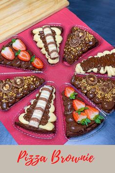 a pizza brownie with chocolate and strawberries in it on a pink platter