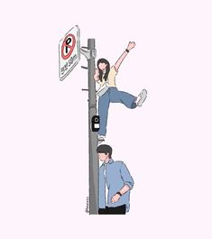 a man and woman standing on top of a street light pole next to a no parking sign