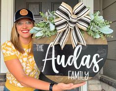 a woman holding up a sign that says the auda's family