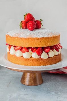 a cake with strawberries and whipped cream on top