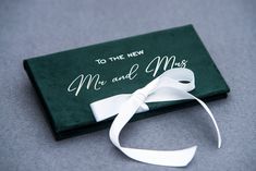 a close up of a book with a ribbon on the front and back cover that says to the new mr and mrs