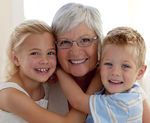 an older woman and two children hugging each other