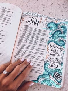 a hand holding an open bible with the words, god