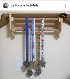 several medals are hanging on a wooden rack