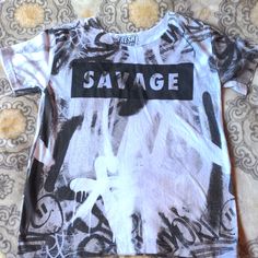 a t - shirt with the word swage on it sitting on a bed