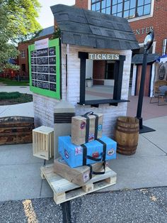 several boxes are stacked on top of each other in front of a ticket booth