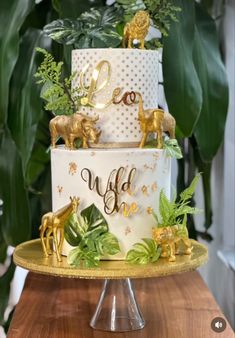 a white and gold cake with animals on top