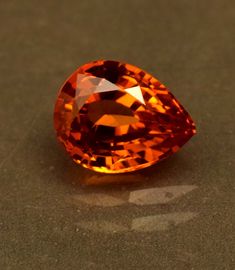 an orange diamond sitting on top of a table