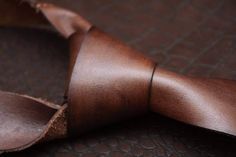 Genuine leather tie.  the tie is regular and you need to tie by your self. We make initials for gift. Classic Brown Ties For Office, Dapper Brown Tie For Business, Classic Brown Suit And Tie Accessories For Father's Day, Classic Brown Suit And Tie Accessories As Gift, Elegant Adjustable Brown Ties, Elegant Brown Adjustable Ties, Adjustable Brown Tie For Black Tie Events, Dapper Ties As Gifts, Dapper Standard Ties For Gift