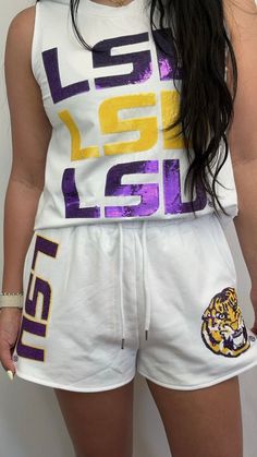 *OFFICIALLY LICENSED BY LSU* The indicia featured on this product are trademarks of Louisiana State University. LSU TIGERS Jogger Shorts (Licensed) | Women's Sequin Design Shorts (White) Calling all LSU Tigers Fans! Check out these Sequin Embroidery Shorts in stunning purple and gold! *Size Chart available for size reference in the images* Features: Sequin Embroidery Material: French Terry | 70% Cotton/ 30% Polyester Please Note: We do not re-stock the same design color/style. Once this item is Lsu Outfits, Tiger Applique, Embroidery Shorts, College Gameday Outfits, Gameday Outfits, College Gameday, Custom Trucker Hats, School Daze, Everyday Purse