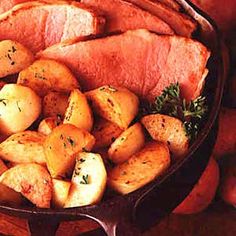 a platter filled with meat, potatoes and carrots