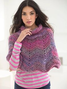 a woman wearing a pink and purple knitted shawl