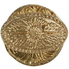 a gold plate with an intricate design on the top and bottom, set against a white background