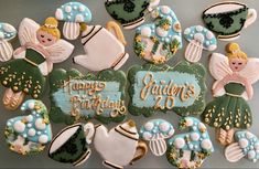 decorated cookies are arranged in the shape of angels and teacups with happy birthday written on them