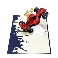 a red race car is on top of a blue and white card with gold foil