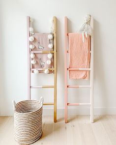 two wooden ladders next to each other in a room with pink and white decor