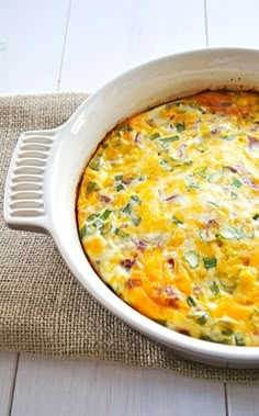 a casserole dish with cheese and vegetables in it