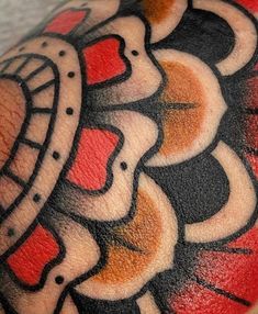 a close up of a person's arm with some tattoos on it and an abstract design