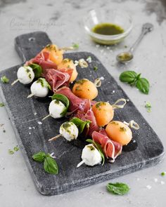 small appetizers are arranged on a cutting board