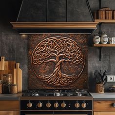 a stove top oven sitting inside of a kitchen next to a wall mounted copper tree of life plaque