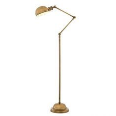 a brass colored floor lamp with a white background