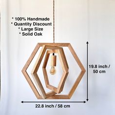 a wooden light fixture with measurements for the size and height, hanging on a wall