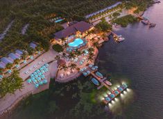 an aerial view of the resort and pool area at night, with lights lit up