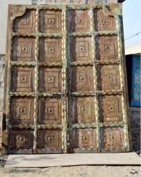 an old wooden door sitting in front of a building