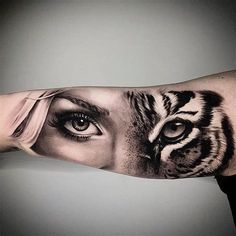 a woman's arm with a tiger face on it and an eye in the middle