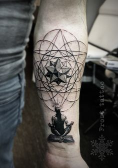 a person with a tattoo on their arm is sitting in front of a flower and star