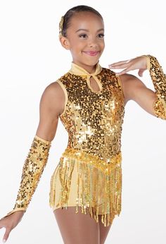 a woman in gold sequins posing for the camera