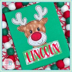 a green shirt with a reindeer on it and the word lincoln written in red letters